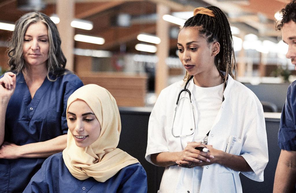 A meeting of a diverse group of doctors and nurses.