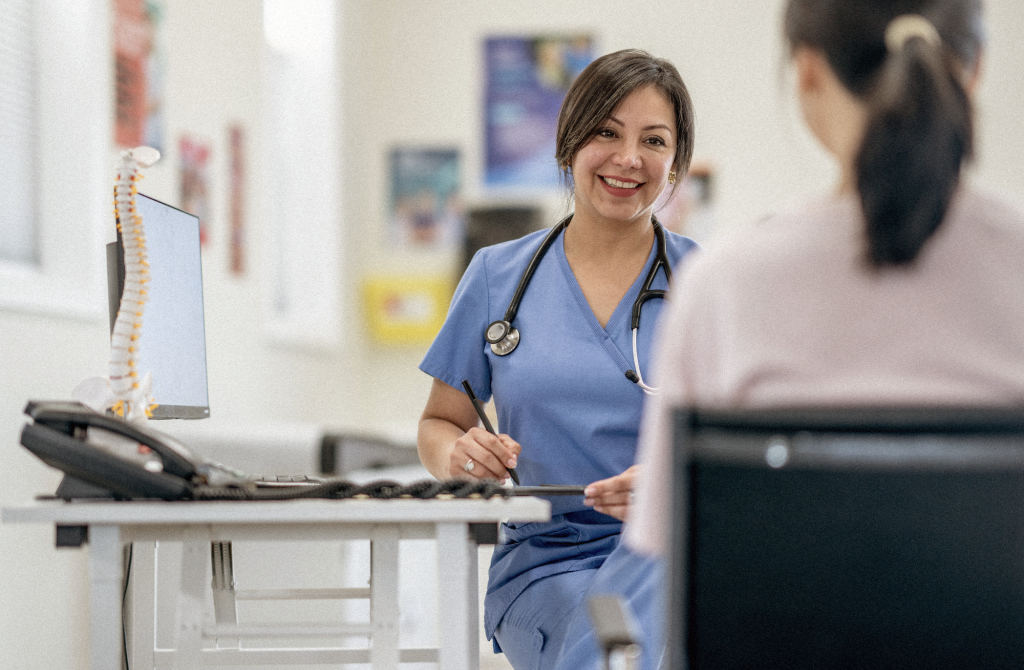 Doctors smiling talking to patient.