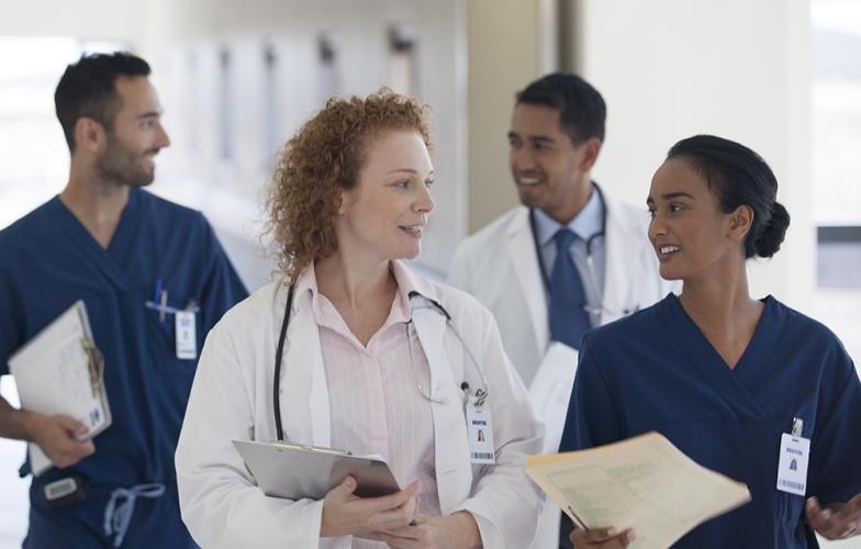hospital_physician_doctor_team_walking_down_corridor_hallway_gettyimages_175139383_stock_photo.jpg