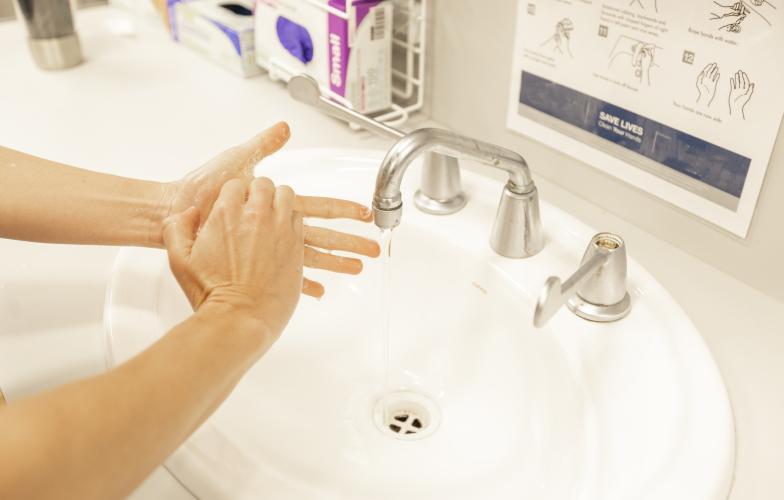 Woman washing hands in a sink