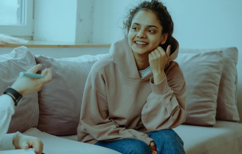 Young woman talking with psychiatrist