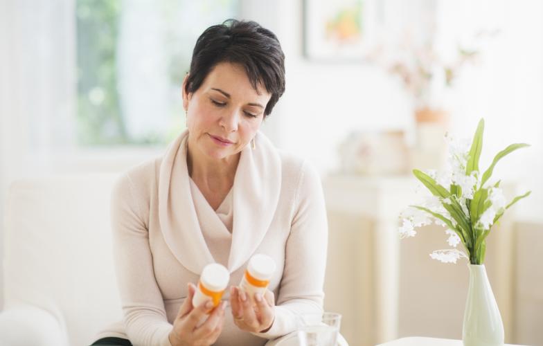 Woman holding medication 