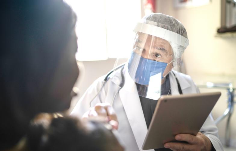 Doctor wearing Personal Protective Equipment in clinic 