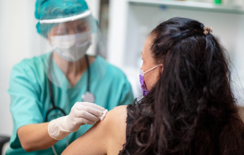 Doctor giving COVID-19 vaccine to patient 