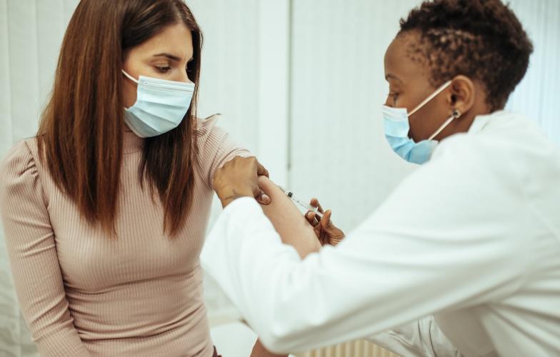 Young woman getting COVID-19 vaccine