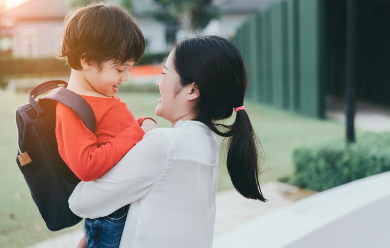 Parent holding school child 