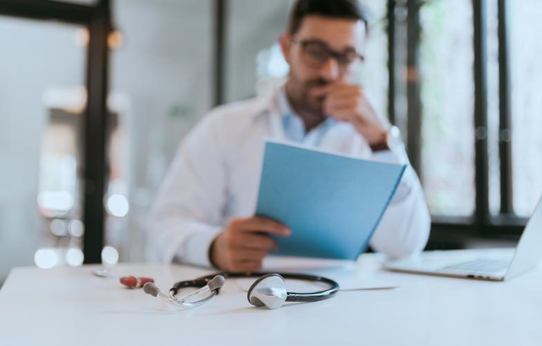 Physician reading document