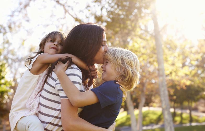 Mother holding her two children 