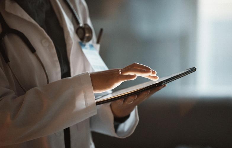 Doctor working on an ipad.