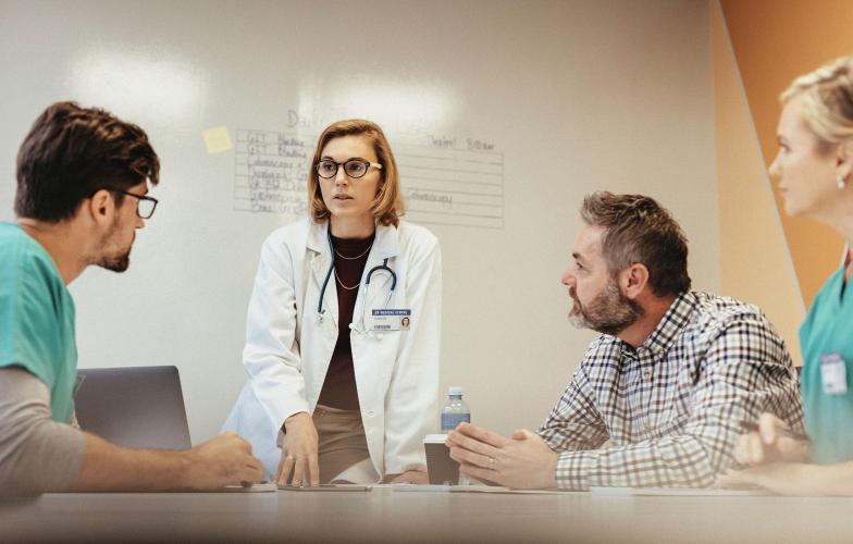 Doctors speaking in a meeting room. 