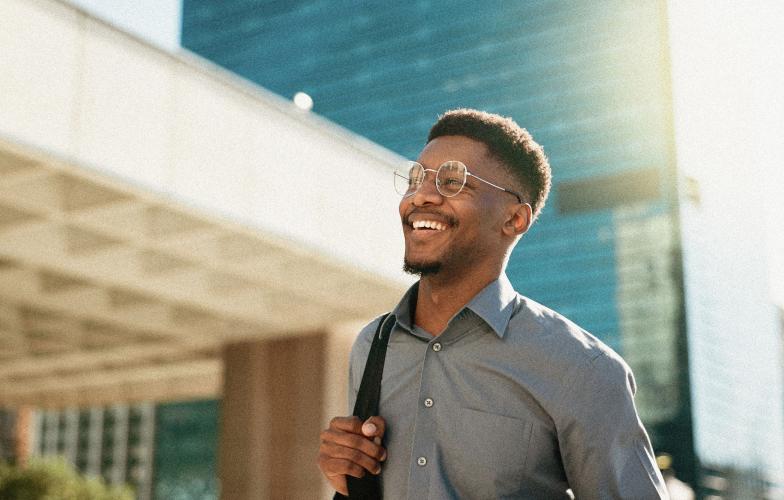 An individual taking a stroll in an urban setting during the day.