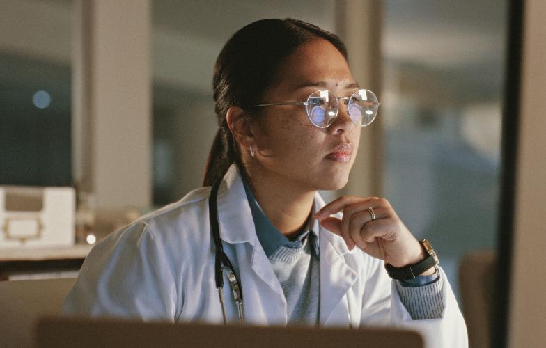 Doctor looking at a screen.