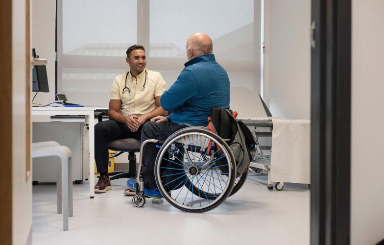 family doctor with patient in wheelchair