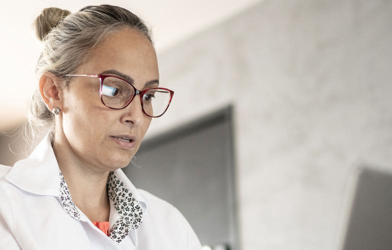 a physician looking at a lap top