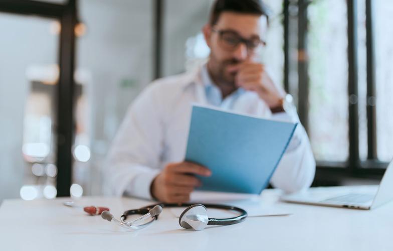 physician looking at a document