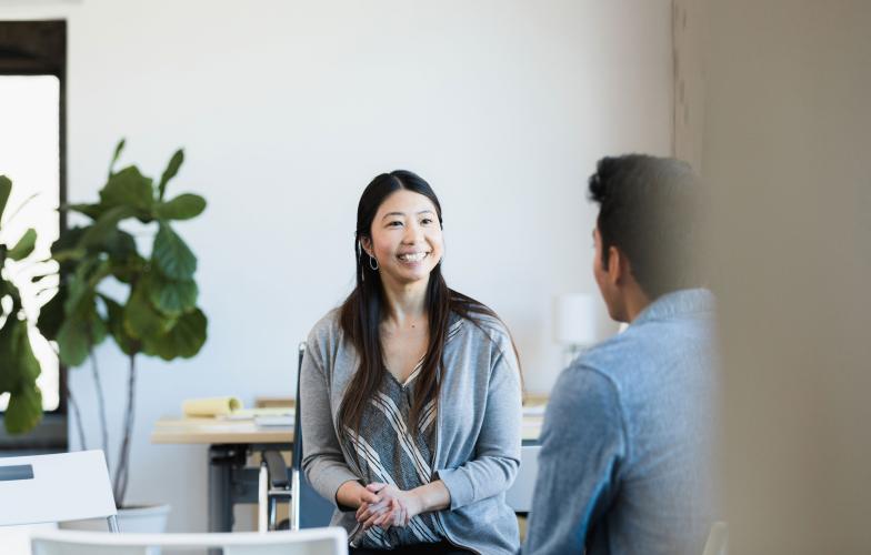woman speaking with a health care colleague