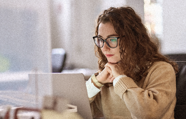 Young woman watching laptop.