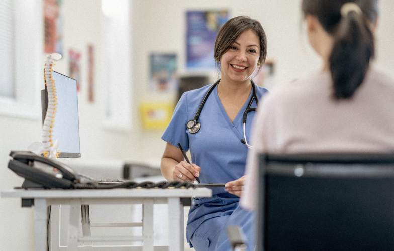 Doctors smiling talking to patient.