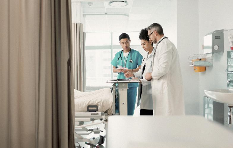 Doctors in hospital room.