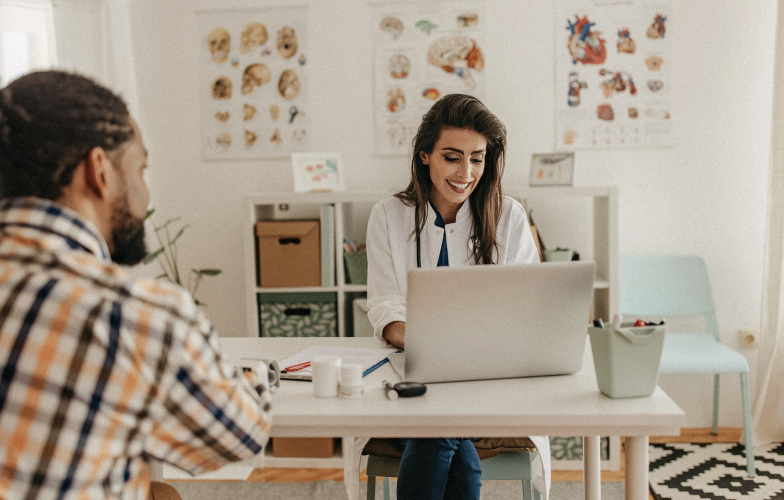 Doctor with a patient on computer.