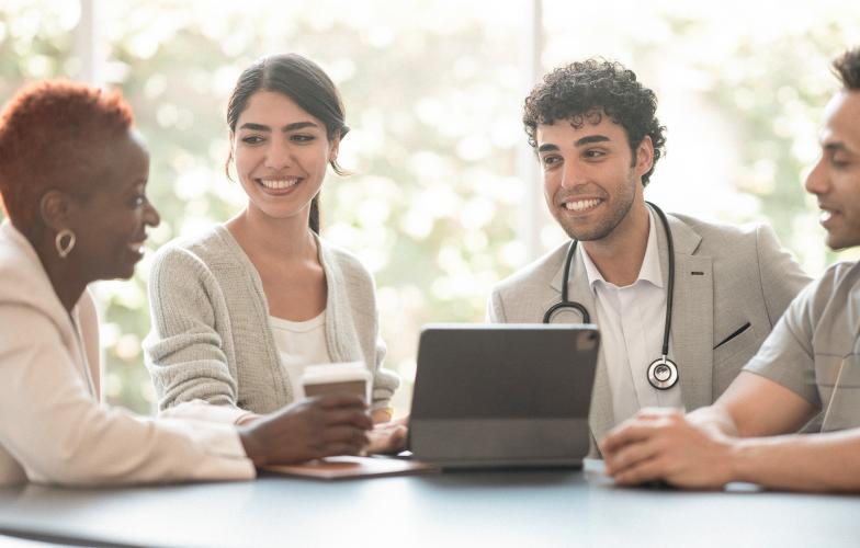 Physician leaders gathered at a table.