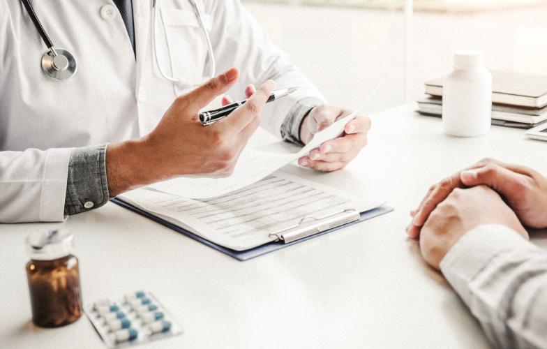 Doctor prescribing medication to patient.