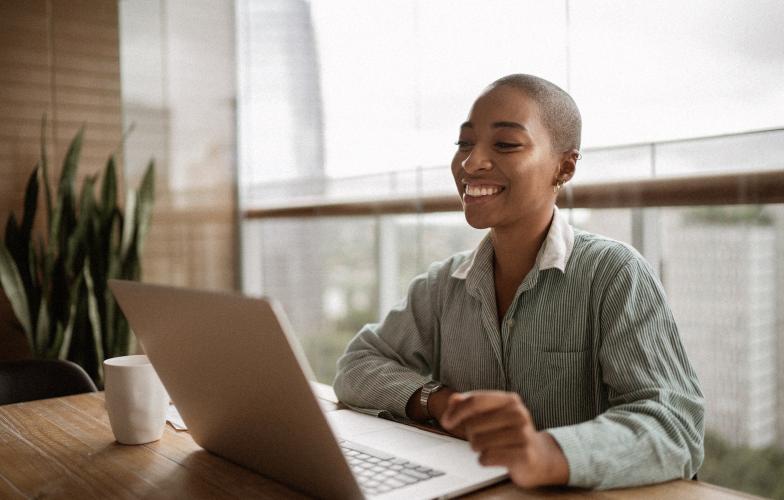 Woman smiling at laptop