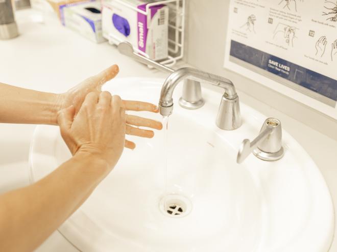 Woman washing hands in a sink