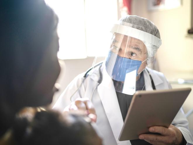 Doctor wearing Personal Protective Equipment in clinic 