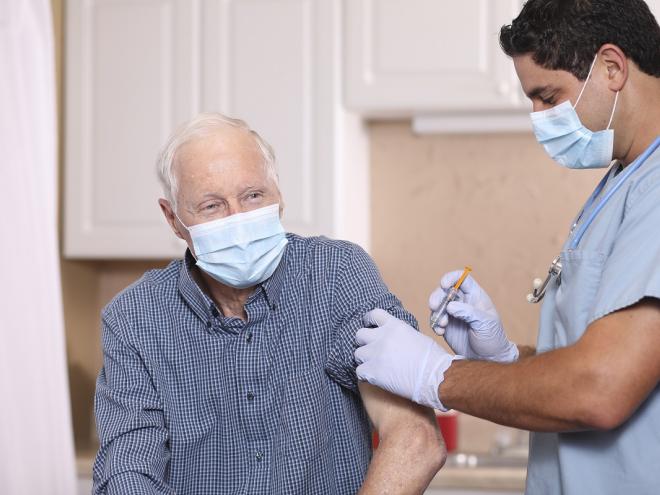 Elderly man receiving flu vaccine 