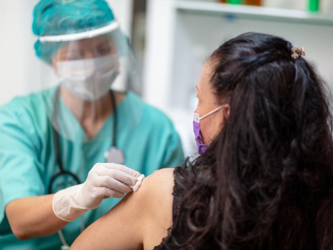 Doctor giving COVID-19 vaccine to patient 