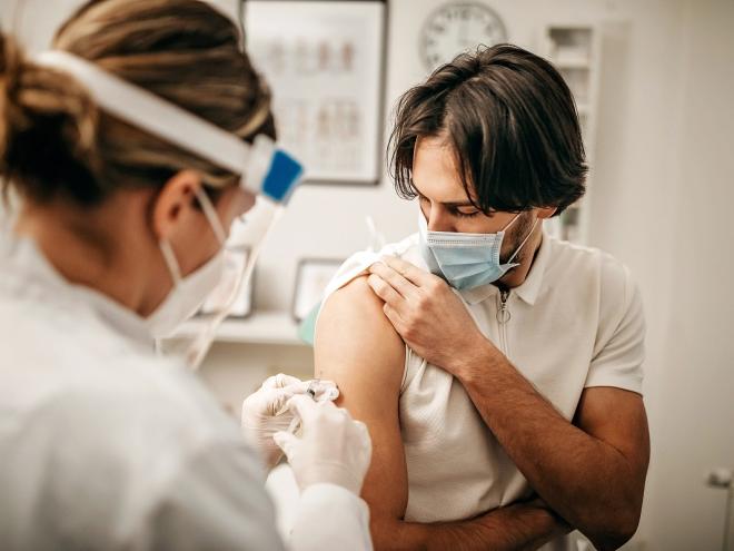 Young man getting COVID-19 vaccine