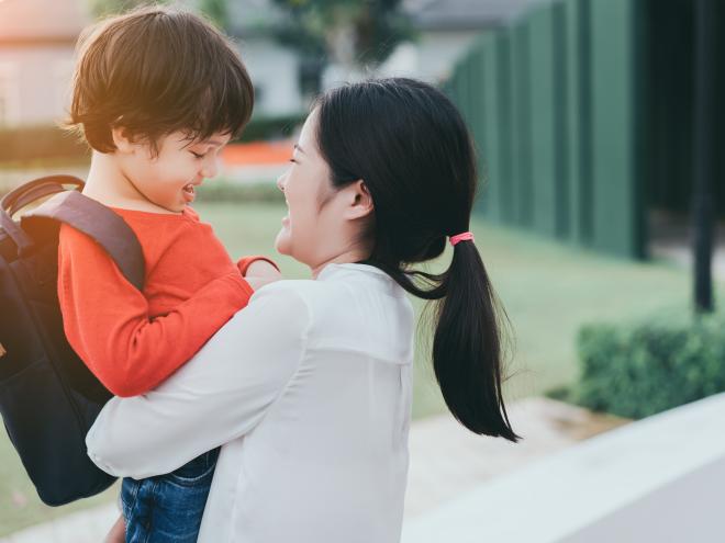 Parent holding school child 