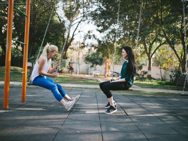 Friends laughing in a park