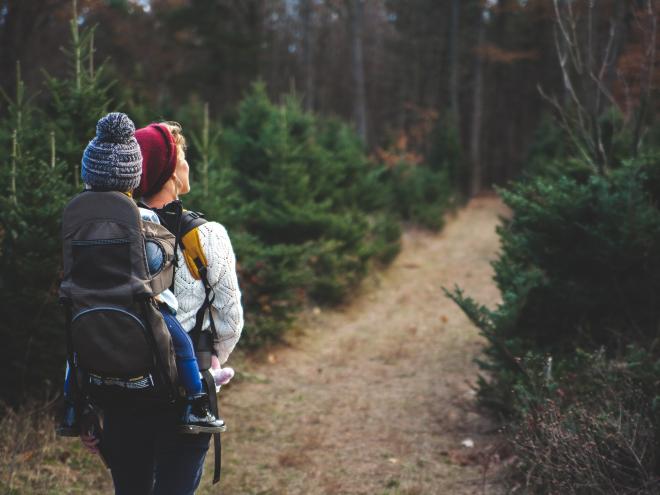 Woman and child hiking in the forest 