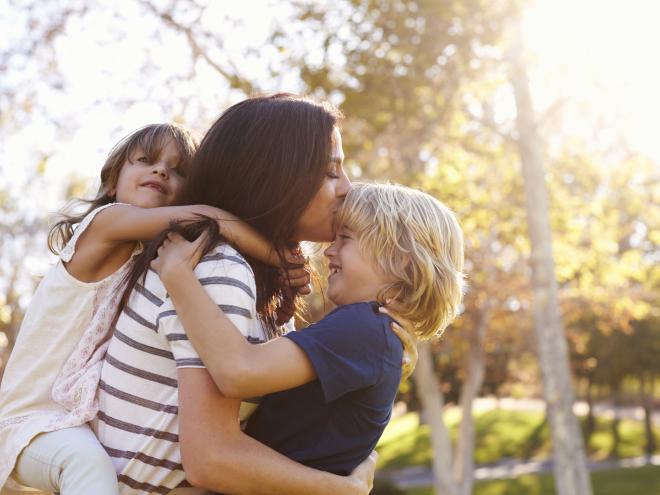 Mother holding her two children 