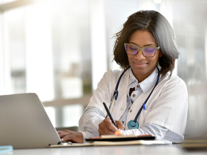 doctor_doing_paperwork_at_desk.png