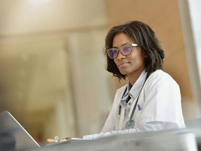 A doctor looking at their laptop. 