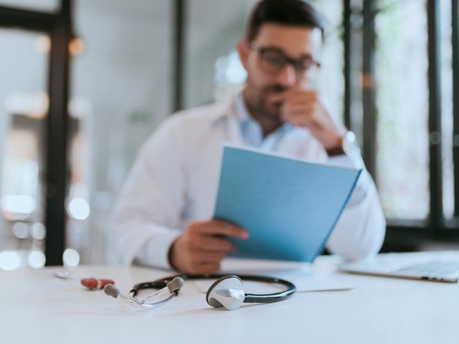 physician looking at a document
