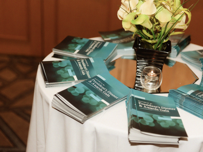 Awards gala booklets on a table.