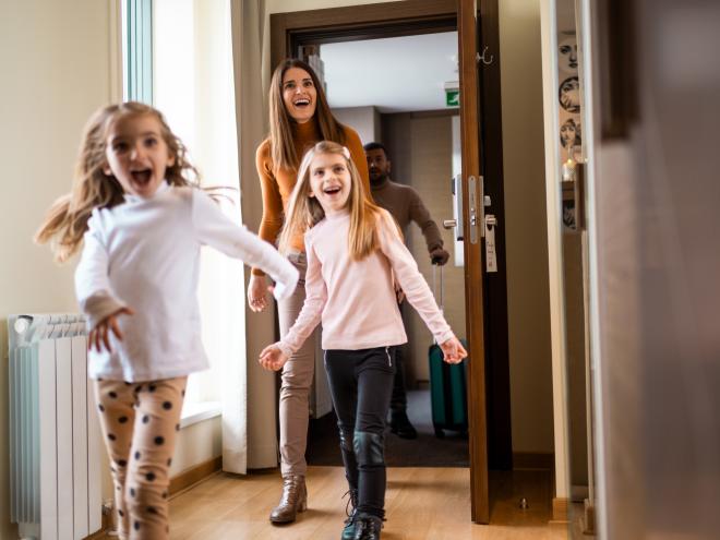 Happy family in a hotel room.