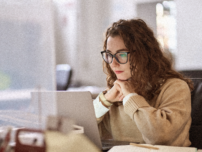 Young woman watching laptop.