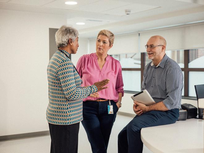 Healthcare professionals talking in office.