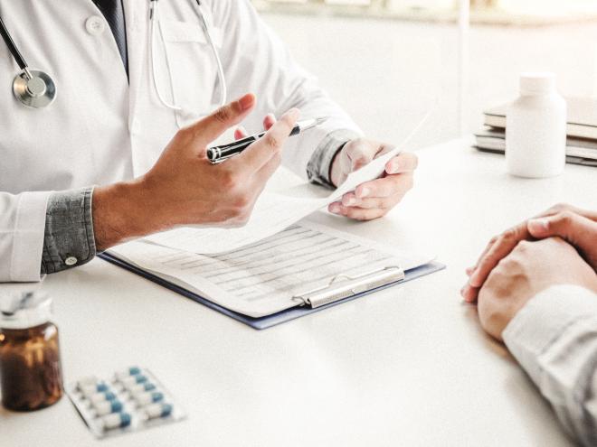Doctor prescribing medication to patient.