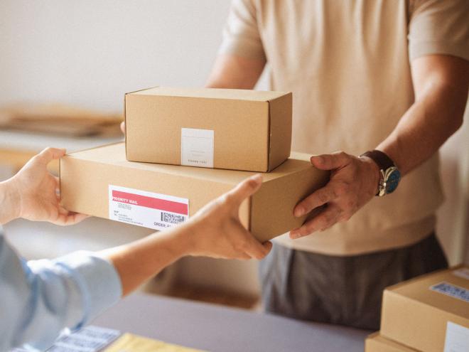 A person accepting a shipment of boxes.