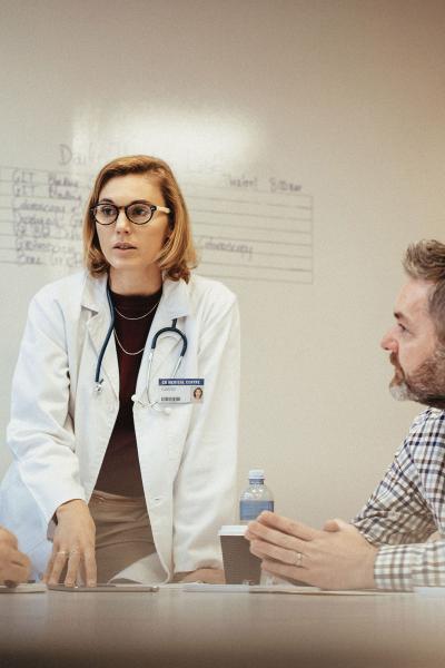 Doctors speaking in a meeting room.