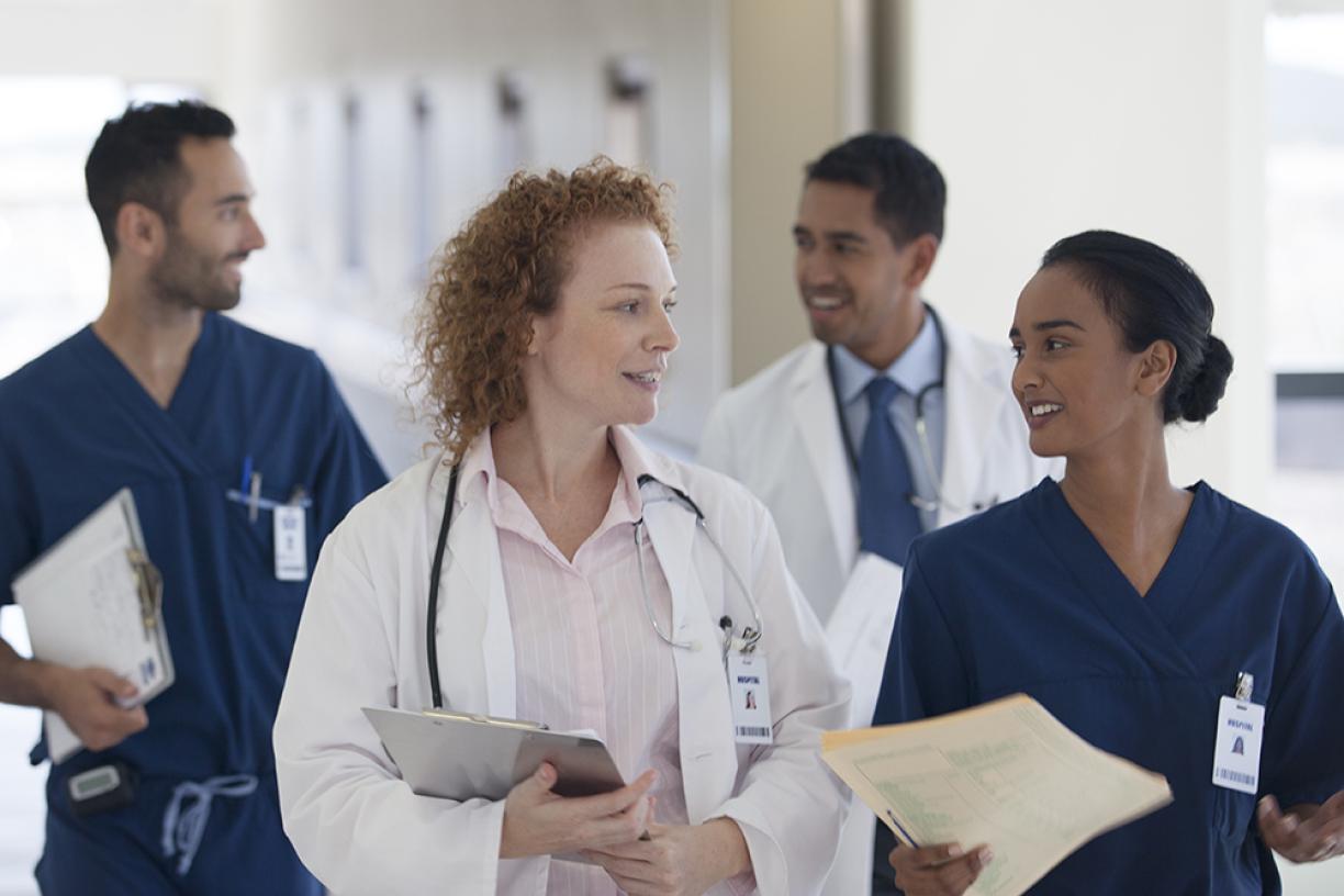 hospital_physician_doctor_team_walking_down_corridor_hallway_gettyimages_175139383_stock_photo.jpg