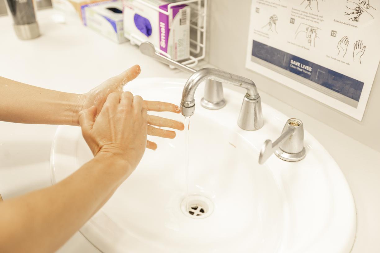 Woman washing hands in a sink