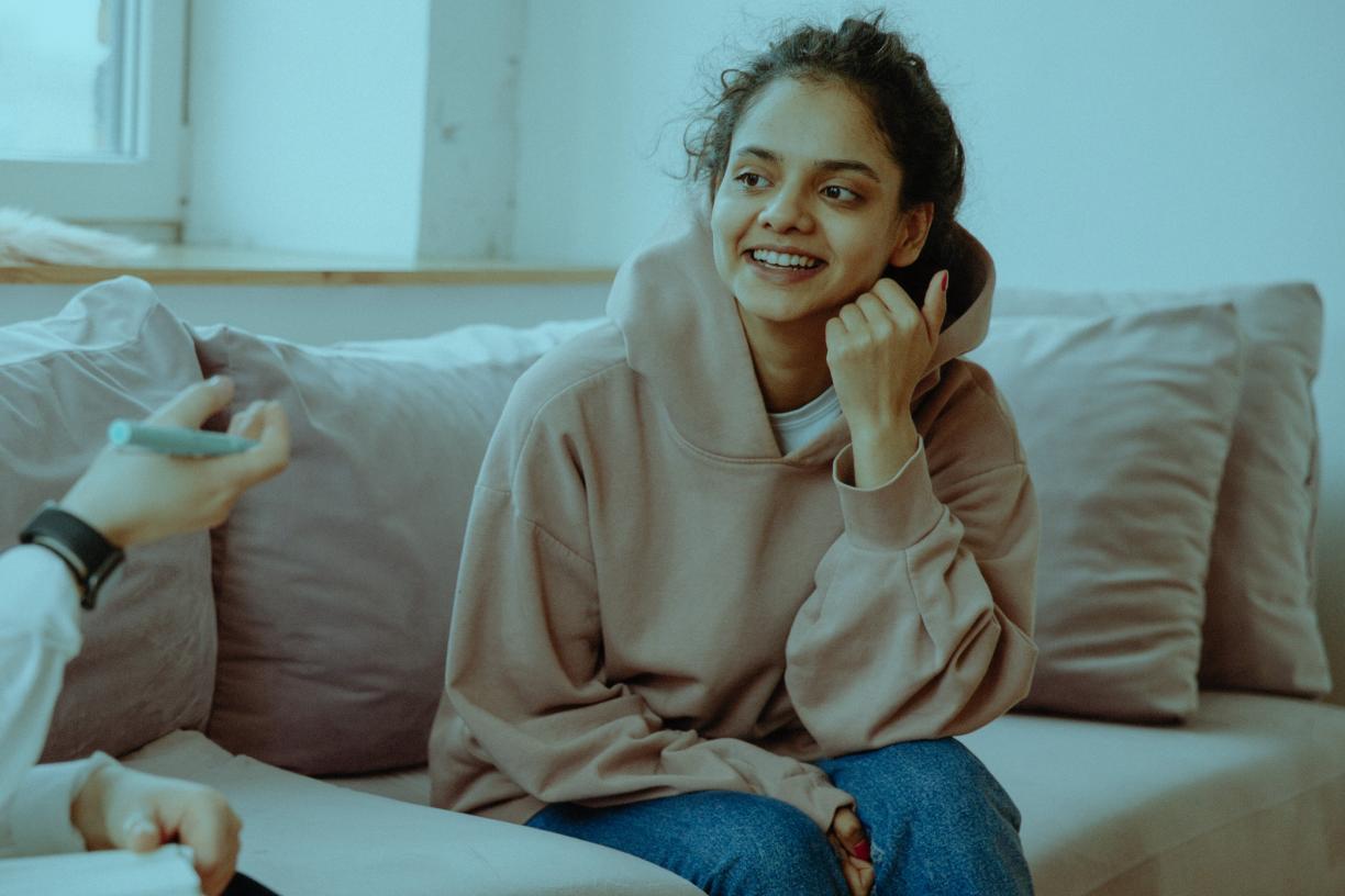 Young woman talking with psychiatrist