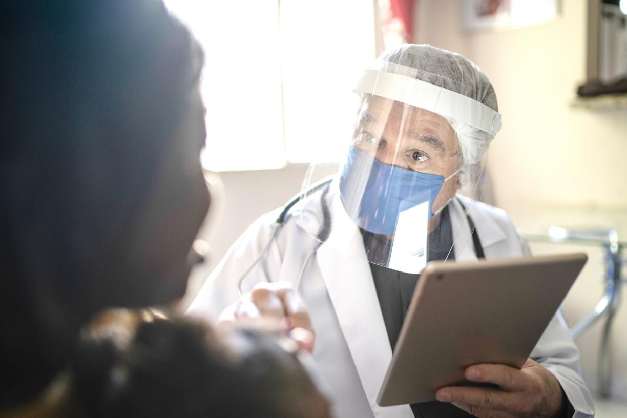 Doctor wearing Personal Protective Equipment in clinic 